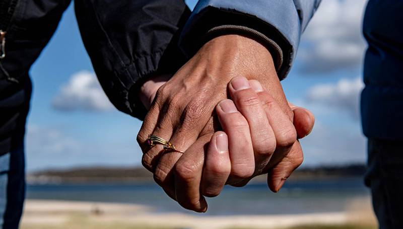 photo of couple holding hands