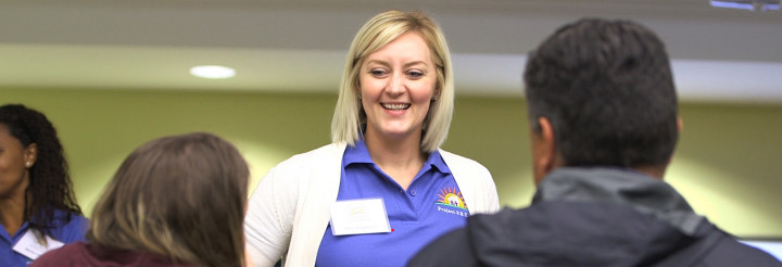 photo of smiling teacher in classroom